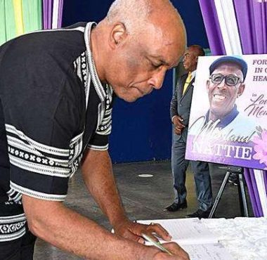 Jamaica Olympic Association President Christopher Samuda signs the condolence book at the entrance to National Indoor Sports Centre in St Andrew before the start of the funeral for former national basketballer Marland Nattie on Saturday, December 3, 2023.