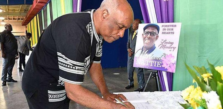 Jamaica Olympic Association President Christopher Samuda signs the condolence book at the entrance to National Indoor Sports Centre in St Andrew before the start of the funeral for former national basketballer Marland Nattie on Saturday, December 3, 2023.